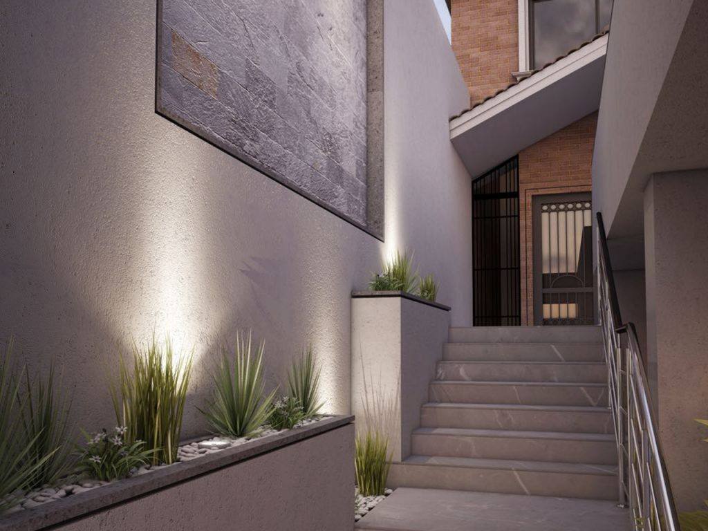 Acceso y escalera exterior iluminada de una residencia construida por Grupo ESAGA